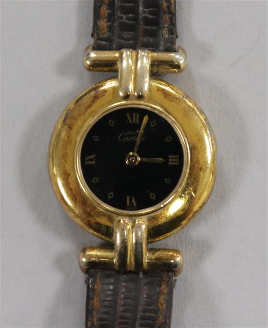 A ladys Must de Cartier silver gilt quartz wrist watch (lacking winding crown).